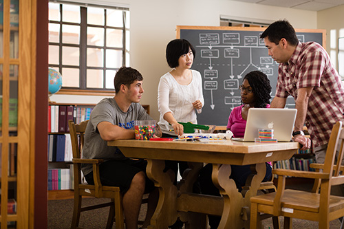 A group of four students work collaboratively on a project.